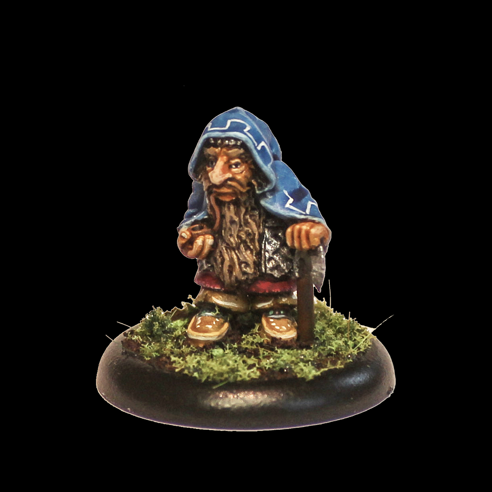 Oakbound Studio Domari. Miniature figurine of a bearded character in blue hooded cloak holding a staff on a black background