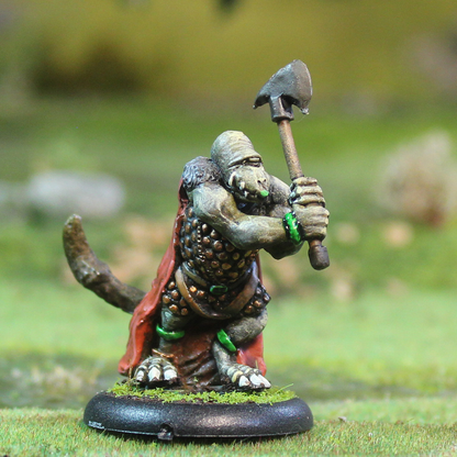 Losbast Snaghyrn 2. Miniature figurine of a fantasy creature holding an axe on a grassy background