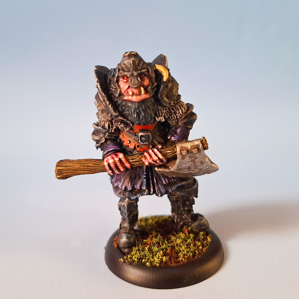 Oakbound Studio Stallu Warchief. Miniature figurine of a warrior with an axe on a plain background