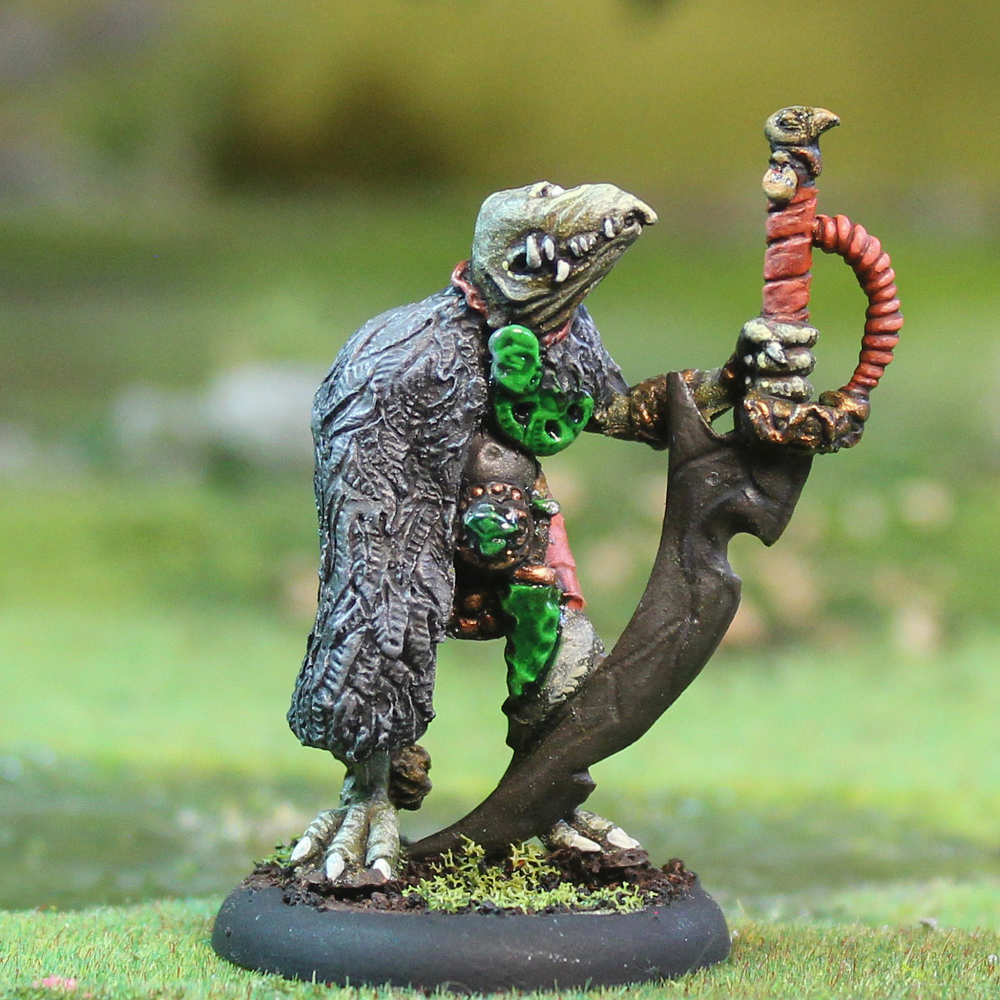Oakbound Studio Warrior Tiarna. Miniature figurine of a lizard-like creature with a sword on a grassy background