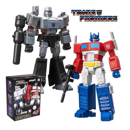 Transformers Optimus Prime action figure shown alongside its retail box, with a large grey and black Decepticon robot figure behind it and the Transformers logo at the top right, all on a plain white background. Optimus Prime and Megatron Transformer 2-Pack - AMK Mini Series Combo Set