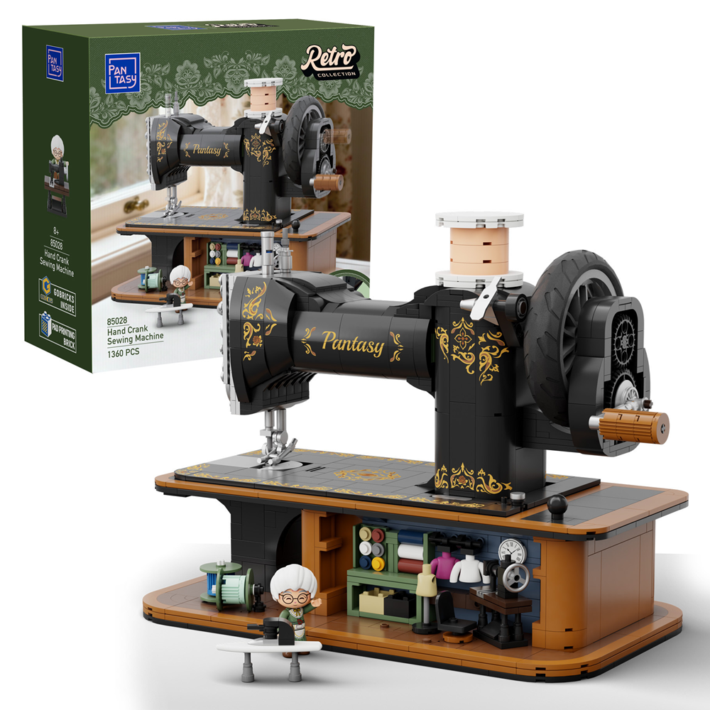 Model sewing machine with detailed design and accessories, displayed in front of its packaging.