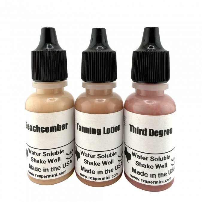 Three bottles of tanning lotion with labels on a white background. Reaper MSP Sunkissed Triad
