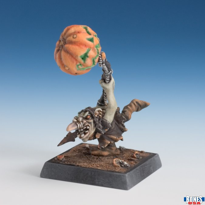 Miniature figure of a creature holding a pumpkin against a gradient blue background. Reaper Miniatures 30271 Pumpkin Nagg