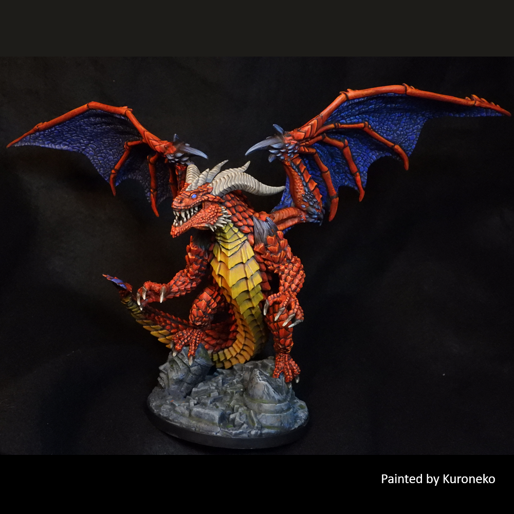 Colorful dragon figurine with red and blue wings on a dark background, painted by Kuroneko. Reaper Miniatures Chaarondar the Cruel Bones Black multipart wyrm miniature 