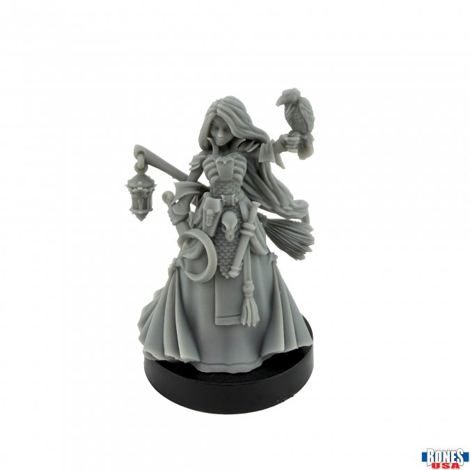An unpainted gray resin miniature figurine of a skeleton witch holding a lantern and a raven, standing on a round black base against a white background.