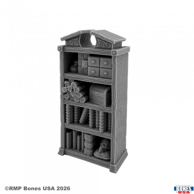 A gray miniature tabletop gaming bookshelf with shelves, books, and storage boxes, shown on a white background with RMP Bones USA copyright text.