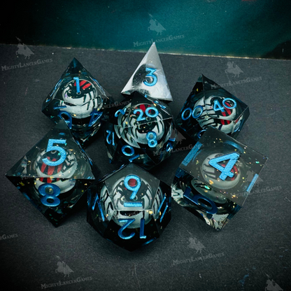 Set of 7 liquid core RPG dice with semi-transparent shells and blue numbers, featuring a suspended red spider inside. Comes in a black case with view window.