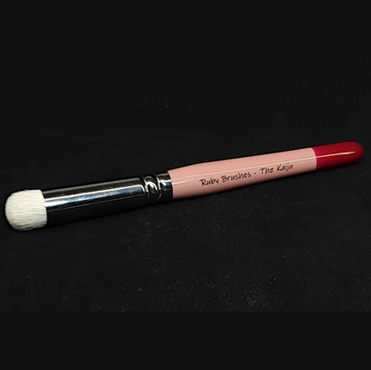 Ruby Brushes The Kaiju Drybrush. miniature painting brush with pink handle and black ferrule on a black background