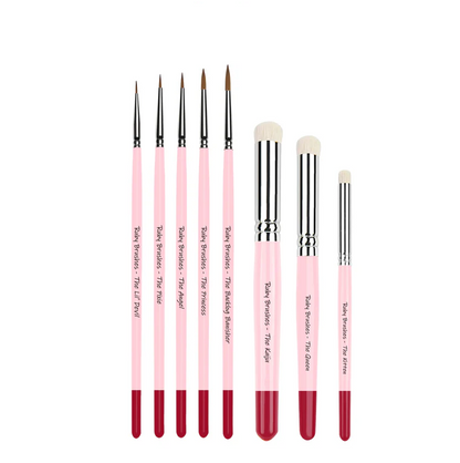 Six-piece Ruby Brushes set including detail brushes and drybrushes for miniature painting.. Set of pink hoby brushes with red tips on a white background