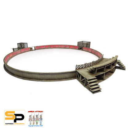 A miniature tabletop gaming terrain piece depicting a circular arena or stadium with tiered wooden stands and a red inner wall, shown on a white background with a 'March Attack!' brand logo in the bottom-left corner. Sarissa Precision Ludus Arena Scenery Set MDF Roman wargaming terrain with arena seating and cages