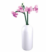 White vase with pink flowers on ...