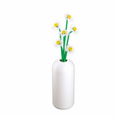 White vase with green stems and ...