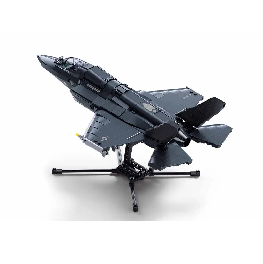 A black and Gray toy fighter jet model displayed on a black stand against a clean white background. Sluban F-35BS Lightning Fighter Jet