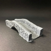 A miniature grey stone bridge or...