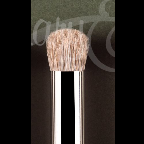 A makeup brush with dense, rounded light beige bristles and a polished silver metal handle, shown against a dark background with a faint watermark. Smooshing Brush XL by Rosemary and Co