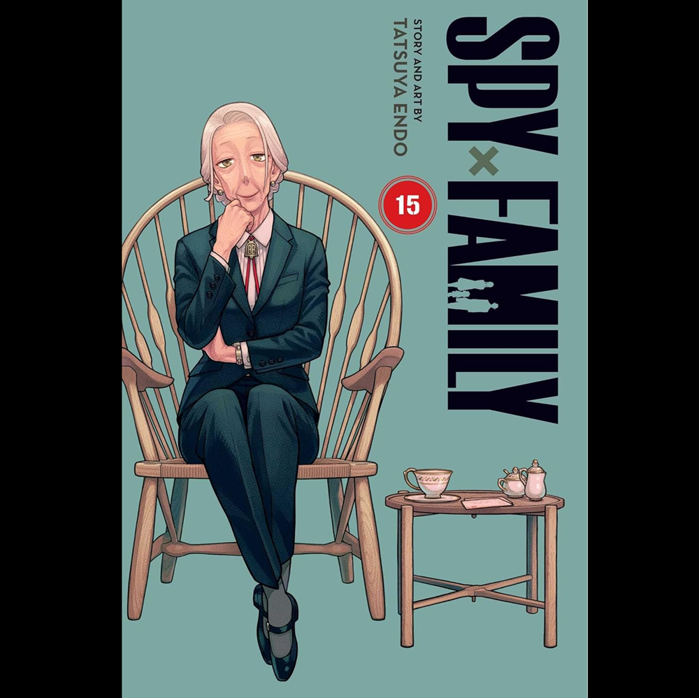 Book cover of 'Spy x Family' with a character in a chair and table setup.