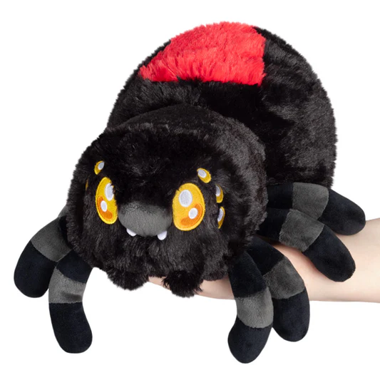 Plush spider toy with red top section held by a hand on a white background. Squishable Black Widow