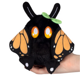 A black plush creature toy with ...