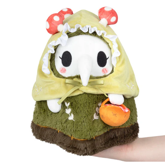 Plush toy resembling a character with a green hood and mushroom ears on a white background. Squishable Woodland Plague Nurse