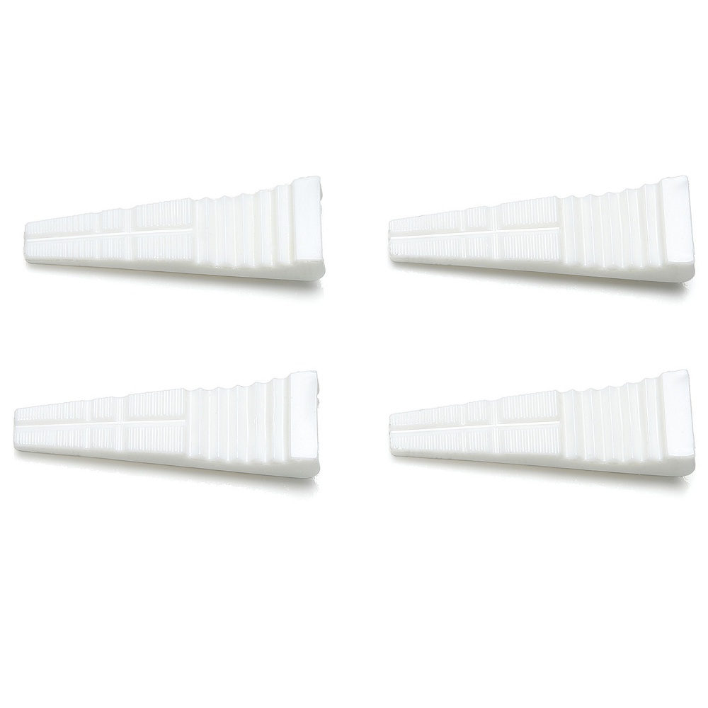 Tamiya Non-Scratch Replacement Jaw Grips. Four white rectangular objects on a white background