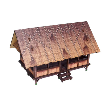 Wooden model of a traditional structure with a detailed roof on a white background