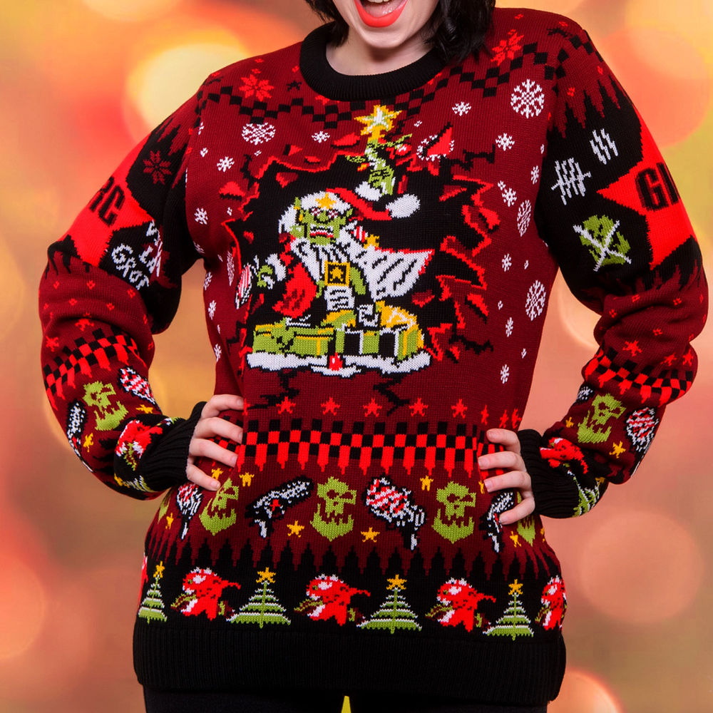 Warhammer 40,000: Red Gobbo Christmas Jumper XXL . Person wearing a festive Christmas sweater with a Grinch design on a blurred background
