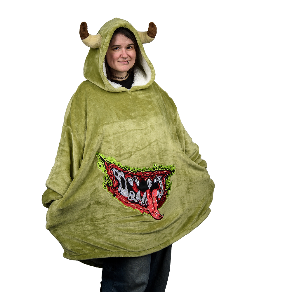 Warhammer Age Of Sigmar: Nurgling Mega Hoodie. Person wearing a green monster-themed poncho with a graphic design on a white background