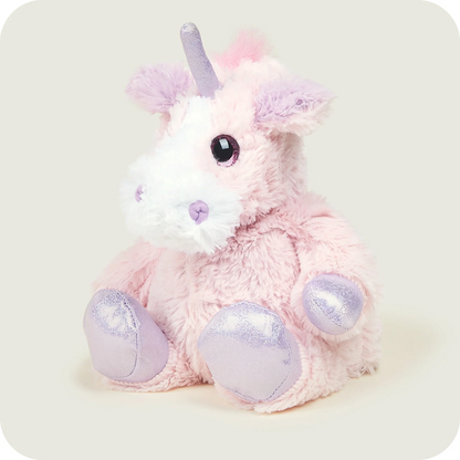 Pink plush unicorn toy with a white horn on a light grey background. Warmies Iridescent Pink Unicorn Microwavable Plushies