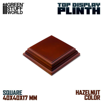 Square MDF display base in hazelnut, featuring a lacquered finish and green baize bottom. Dimensions: 4x4 cm top, 17 mm height, 5.6x5.6 cm base.