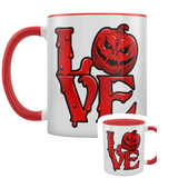 A white mug with a red handle and inner and a red and black Love design featuring a pumpkin as the O.