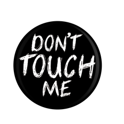 A black badge with Don't Touch Me in white writing