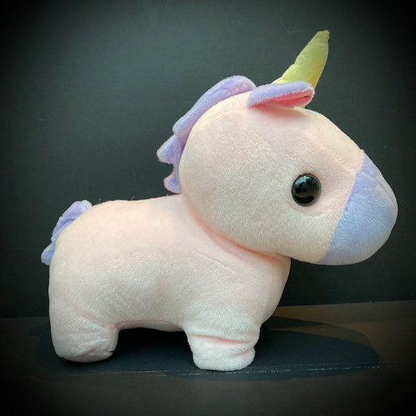 A super cute cuddle club pink chibi unicorn with a peach star detail, yellow horn, purple mane, tail and muzzle, large head and stumpy legs in the typical chibi style.