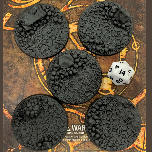A pack of five resin round 50mm bases adorned with skulls