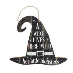A hanging sign in the shape of a witches hat which reads ' A Witch Lives Here With Her Little Monsters'