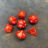 7 red RPG dice with white number...