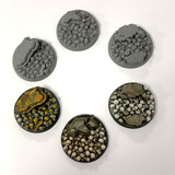 A pack of five resin 25mm bases adorned with skulls