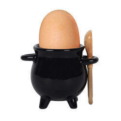 black cauldron egg cup and broom spoon shown with egg