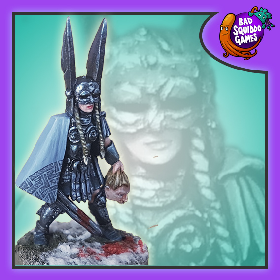 Skálmöld The Valkyrie from Bad Squiddo Games is a wonderful miniature of a Norse mythology Valkyrie on the battlefield with her sword in one hand and a head in the other, she is wearing a cape, has four plates/braids and a large winged helmet on her head
