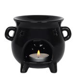 A black cauldron design oil burner with cut out star designs