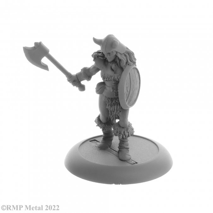 Jana Frostwind Barbarian from the Dark Heaven Legends metal range by Reaper Miniatures, holding a shield in one hand and wearing a horned helm and fur topped boots this metal miniature has a choice of sword or axe for her other hand