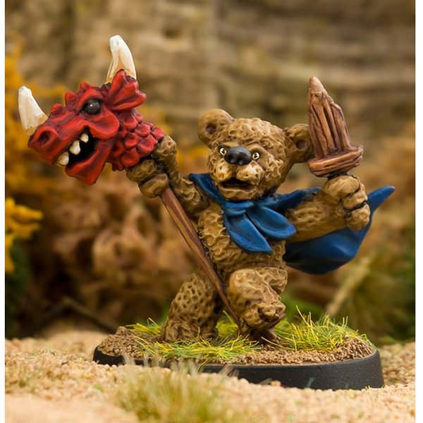 The Dragon Rider by Northumbrian Tin Solider is a metal miniature of a teddy bear wearing a cloak, carrying a wooden sword and playing with a dragon hobby horse. 