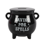 A black cauldron design money box with white 'saving for spells' text on the front