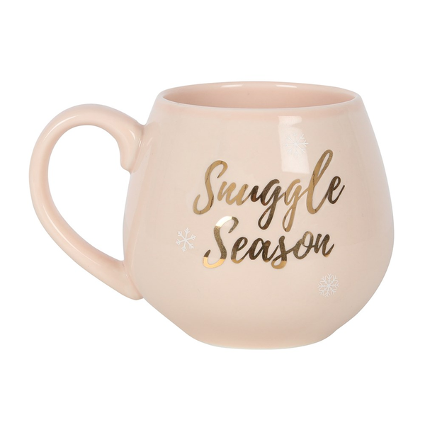 A beautiful soft pink coloured rounded mug with gold writing saying 'Snuggle Season'.