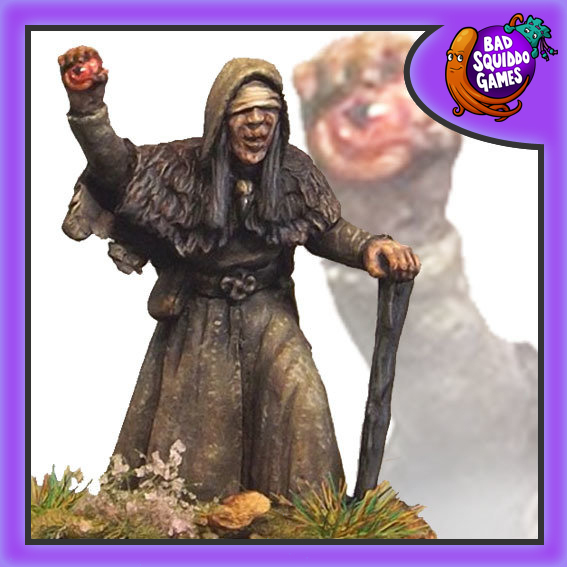 Bad Squiddo Games metal gaming miniature the seer. She has a bandage around her eyes, with a stick in one hand to aid her in walking and am eye held up in the other as if she is using this to see not only where she is going but also into the future, maybe even into another dimension. 