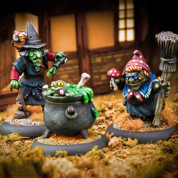 Toil And Trouble by Northumbrian Tin Solider is a set of 3 miniatures, two witches and a cauldron. One witch has a walking stick and pointed hat, one holds a broom and a mushroom and the cauldron contains the spell being cooked up and a frog attempting to escape. 
