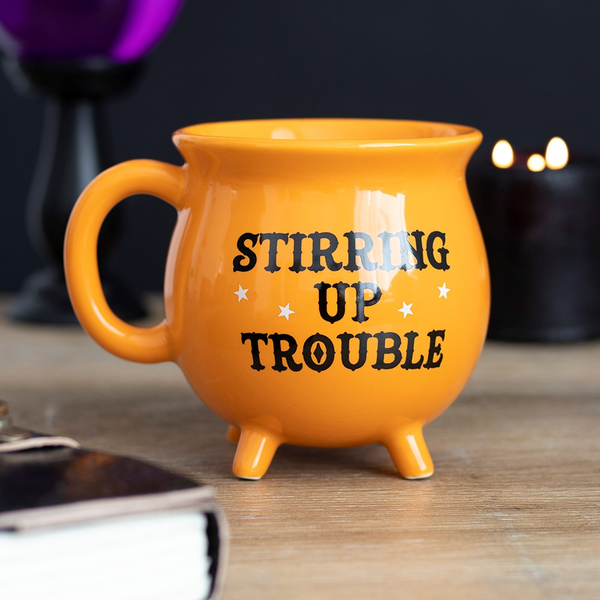  Cauldon mug in orange with the words 'Stirring Up Trouble' in black and white star detail.