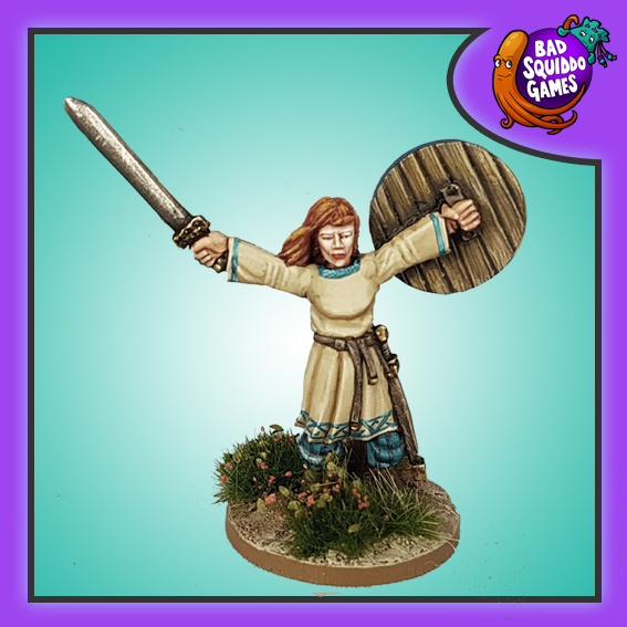Bad Squiddo Games Metal gaming figure. Dagmar Shieldmaiden Champion by Bad Squiddo Games stands with her arms outstretched to each side and a sword in one hand and shield in the other