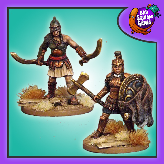 Bad squiddo Games metal gaming miniature. wo fierce amazon fighters ready for action, one holds a weapon in each hand and the other a shield draped in a fur in one hand and an axe in the other