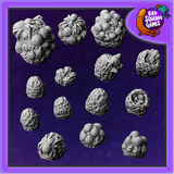 A pack of fourteen resin spiders eggs in various sizes including some with spiders by Bad Squiddo Games